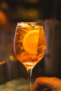 A vibrant Aperol Spritz served with ice and an orange slice, perfect for cocktail lovers.