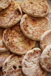A pile of freshly baked traditional flatbreads, perfect for any meal.